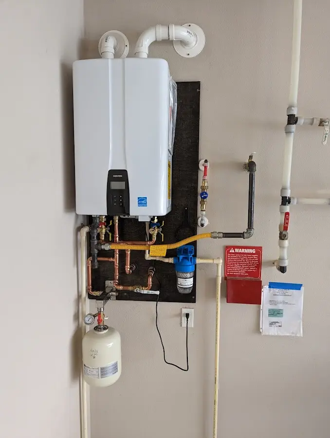 Professional plumber installing copper piping in a Moxee home